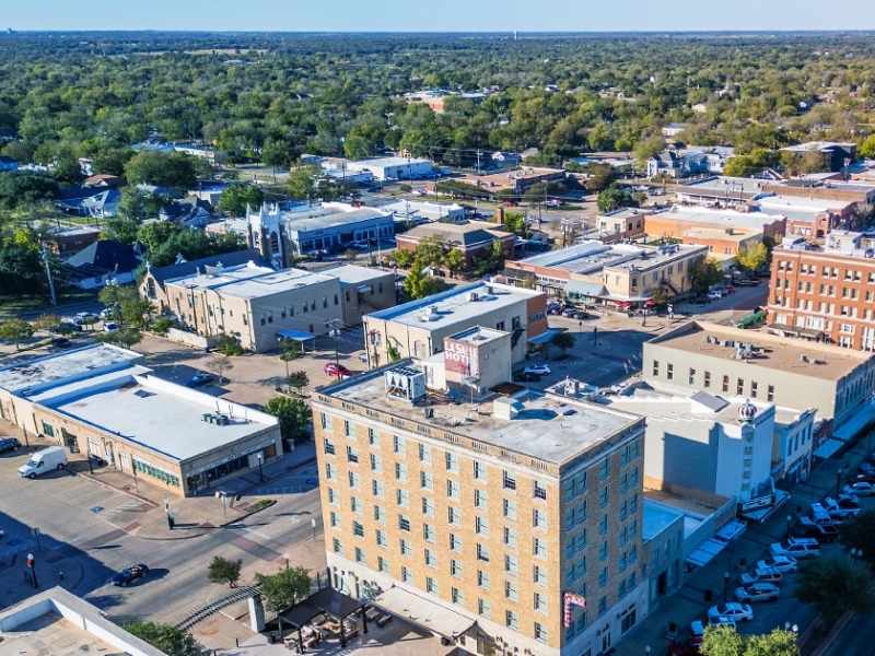 Aerial view of downtown Bryan, Texas with commercial buildings, surrounding properties, and development areas relevant to land surveying and site planning